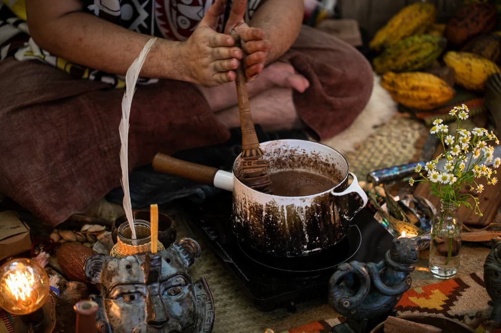 Traditional cacao preparation with whisking and ritual objects