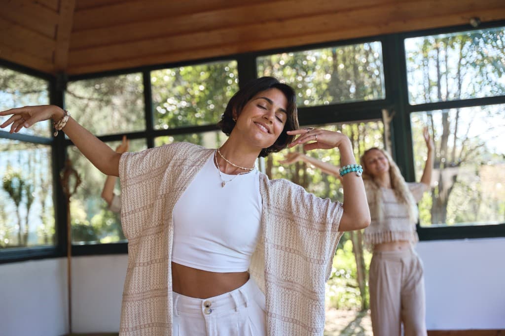 Women practicing mindful movement in a bright studio